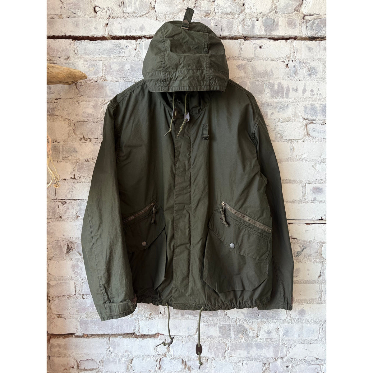 Men's Barbour Westoe showerproof jacket in Breen and Pigment Olive, shown with its waterproof fabric and adjustable hood.