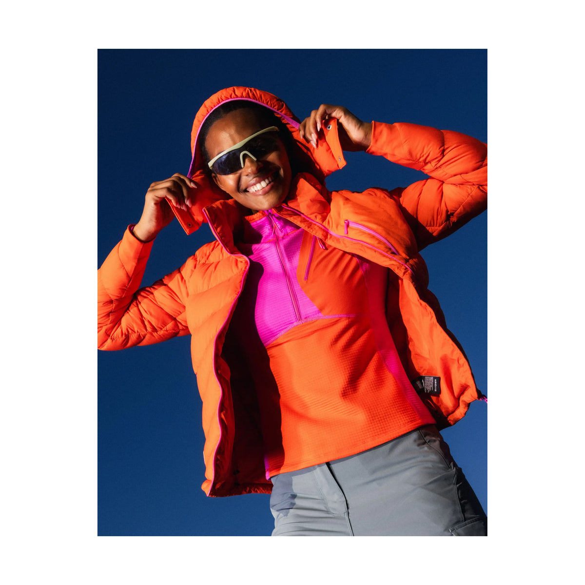 Women's Wildpuff packable removable hood jacket by Seniq, in spicy color, featuring lightweight insulation and a stylish, functional design.