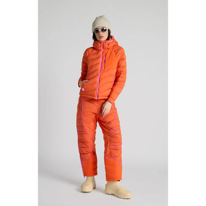 Women's Wildpuff Packable Removable Hood Jacket by Seniq in spicy color, shown with the hood removed and the jacket folded.