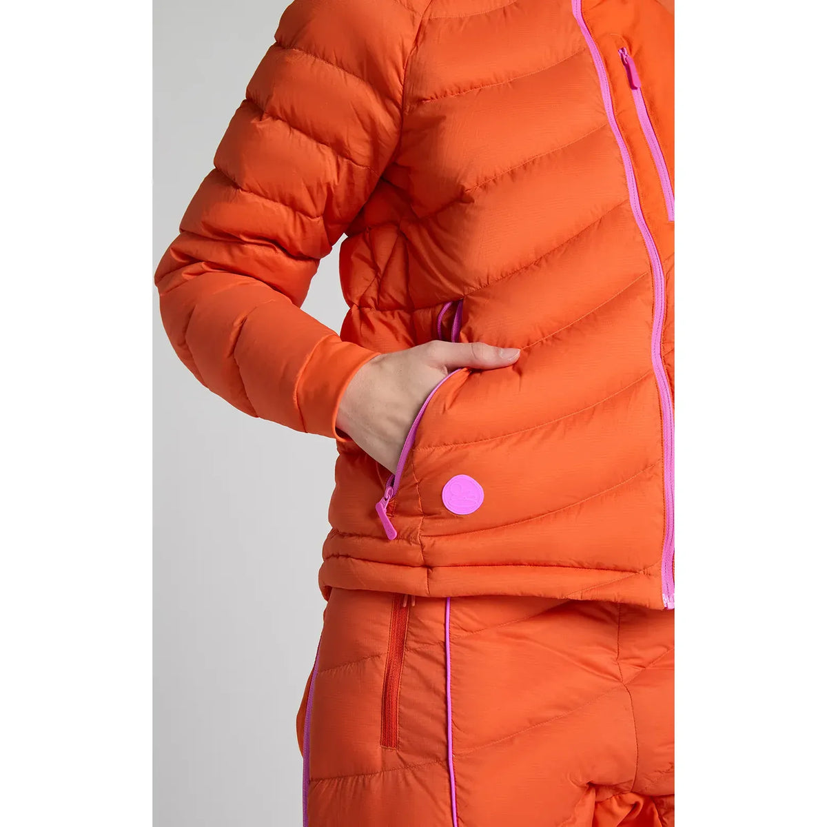 Women's Wildpuff Packable Removable Hood Jacket by Seniq, spicy color, lightweight and stylish with a removable hood, shown in the look.