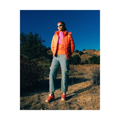 Women's Wildpuff packable removable hood jacket by Seniq in spicy color, showing the lightweight design and hood details.