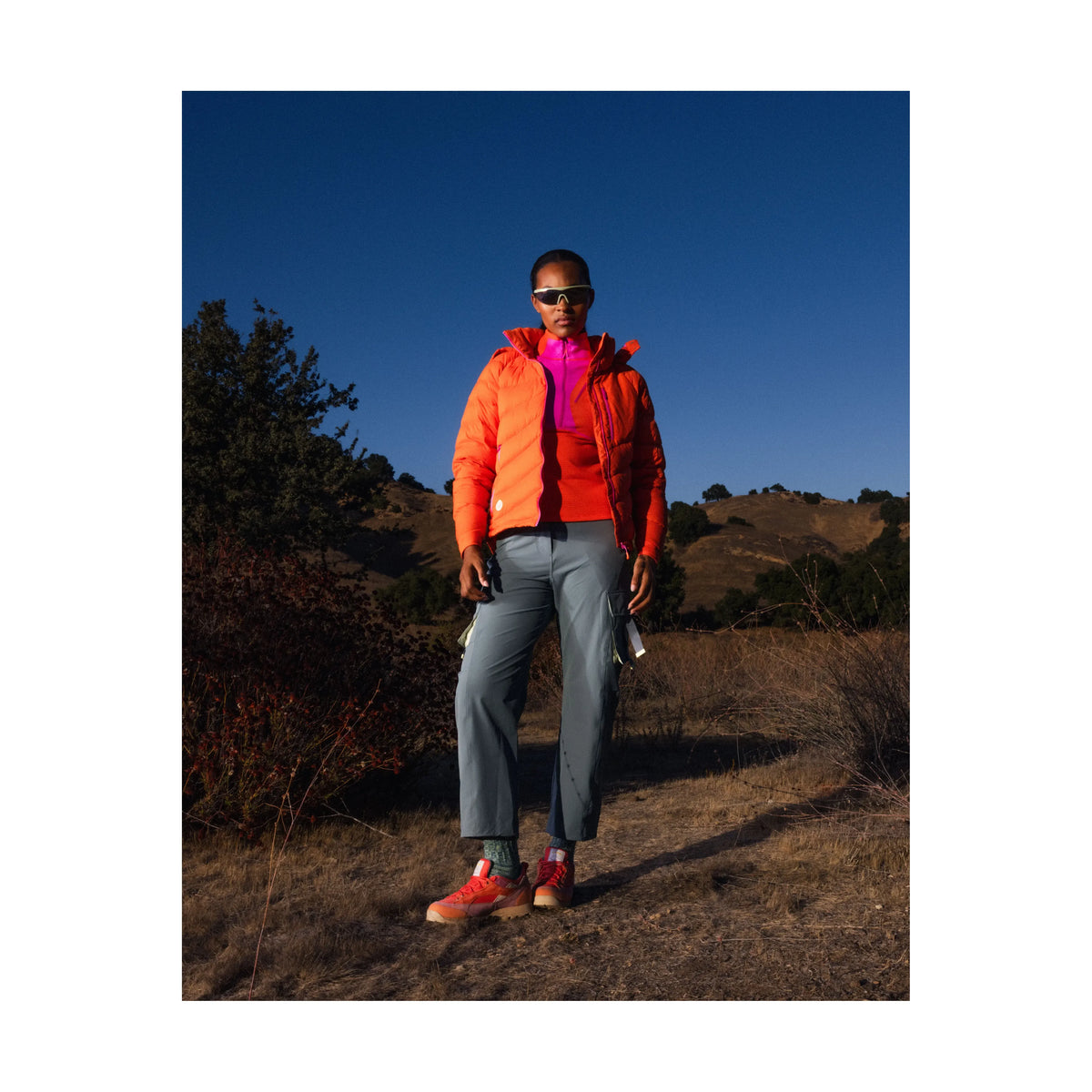Women's Wildpuff Packable Removable Hood Jacket by Seniq in spicy color, showing the lightweight, stylish design with removable hood.