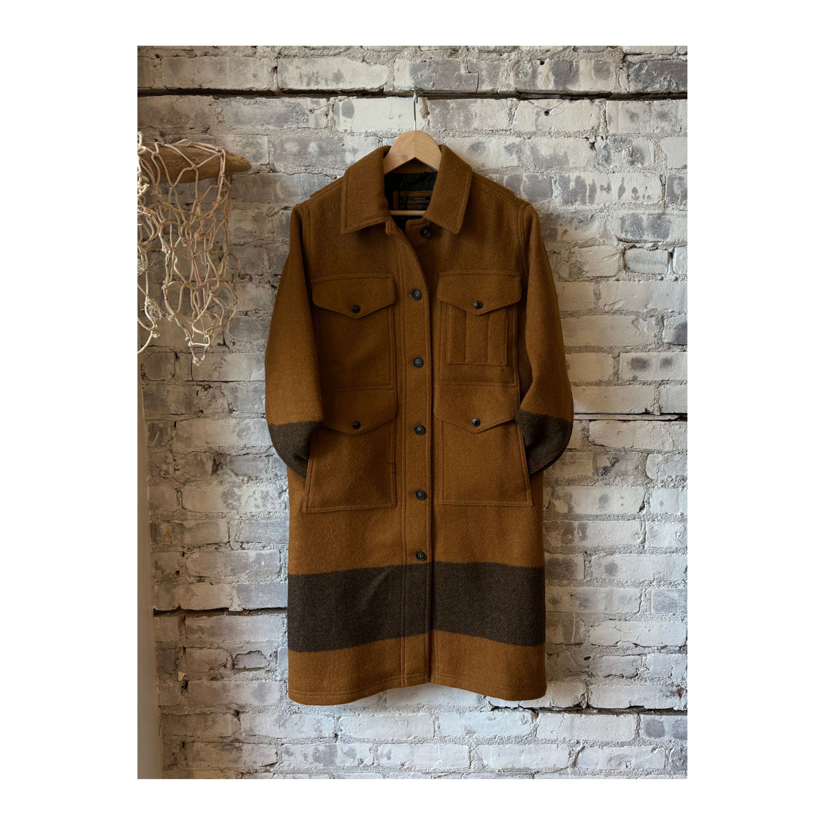 Women's Wool Long Cruiser Coat by FILSON in whiskey and black stripe, featuring a classic tailored design and warm wool fabric.