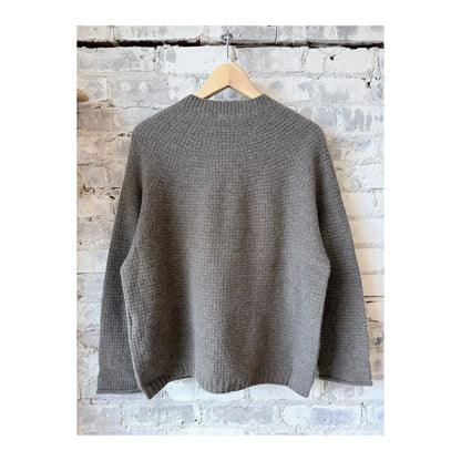 Women's wool cashmere pullover in greige by Pas De Calais, shown in a close-up of the soft, textured knit fabric.