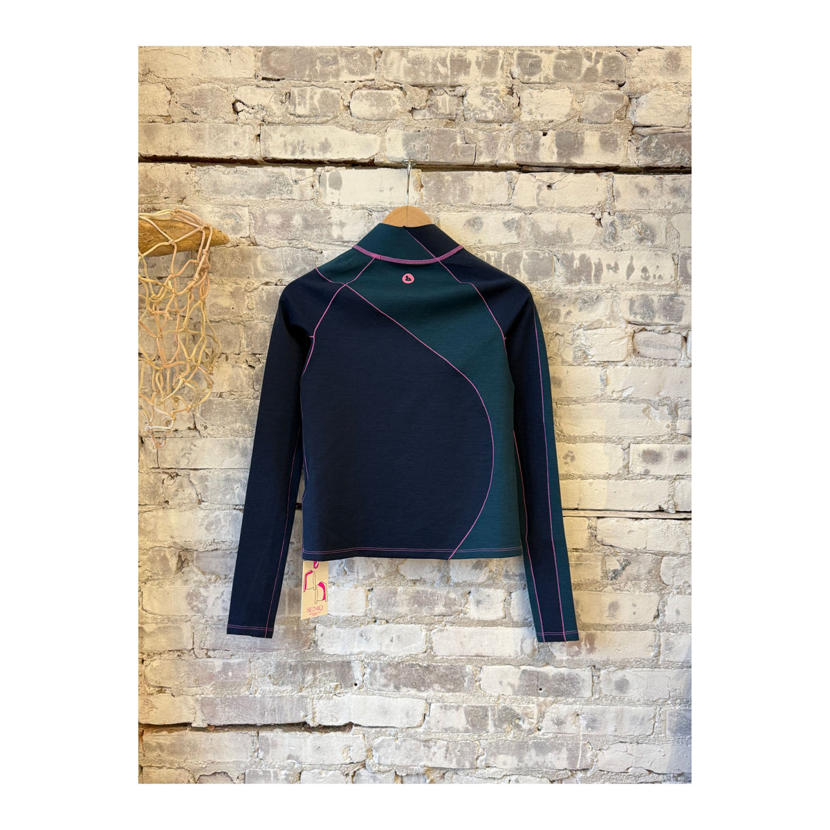 Women's Wool Sculpt Merino Mock Neck sweater by Seniq, featuring a close-up of the soft, fitted mock neck in wool fabric.