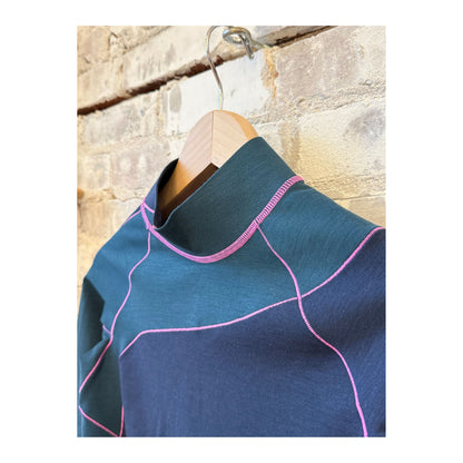 Women's Wool Sculpt Merino Mock Neck sweater by Seniq, featuring a close-up of the soft, fitted Merino wool fabric in a neutral color.
