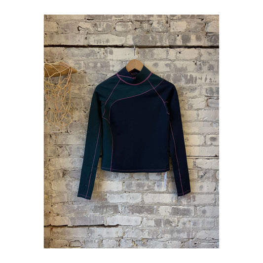 Women's Wool Sculpt Merino Mock Neck sweater by Seniq, featuring a close-up of the soft, fitted mock neck in neutral wool fabric.