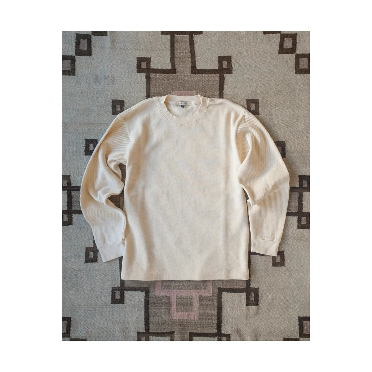 Men's Wythe cotton long-sleeve thermal shirt in cream, shown flat with visible ribbed cuffs and neckline.