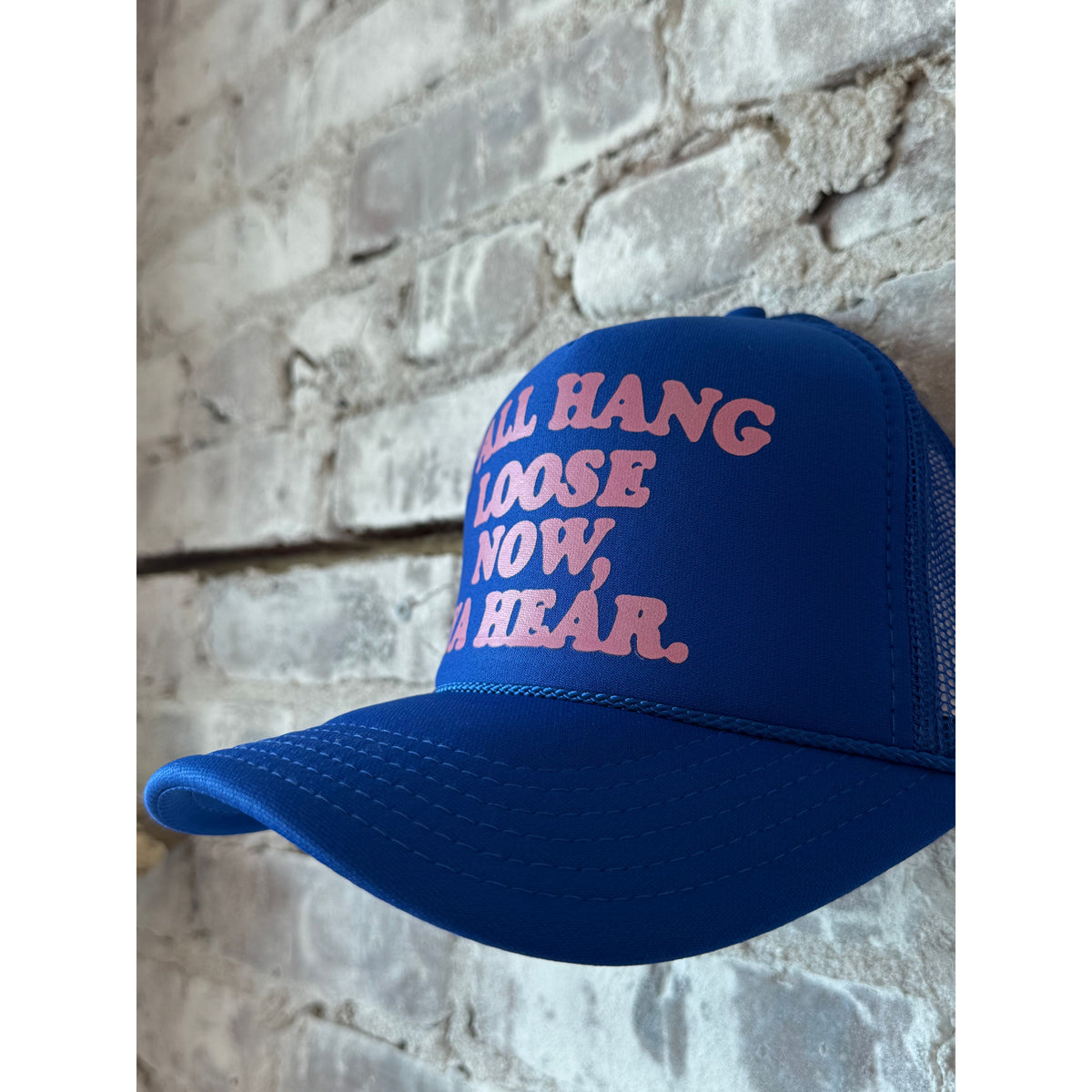 Royal blue and pink Y'all Hang Loose Trucker Hat by N.B. GOODS, featuring mesh back and adjustable snap closure.