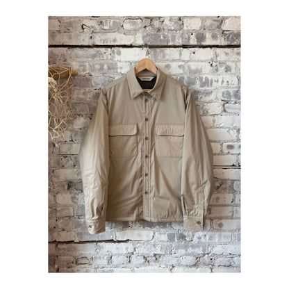 Men's Aspesi Yoshitaka cotton nylon shirt jacket in colonial beige, shown hanging with front view and button details.