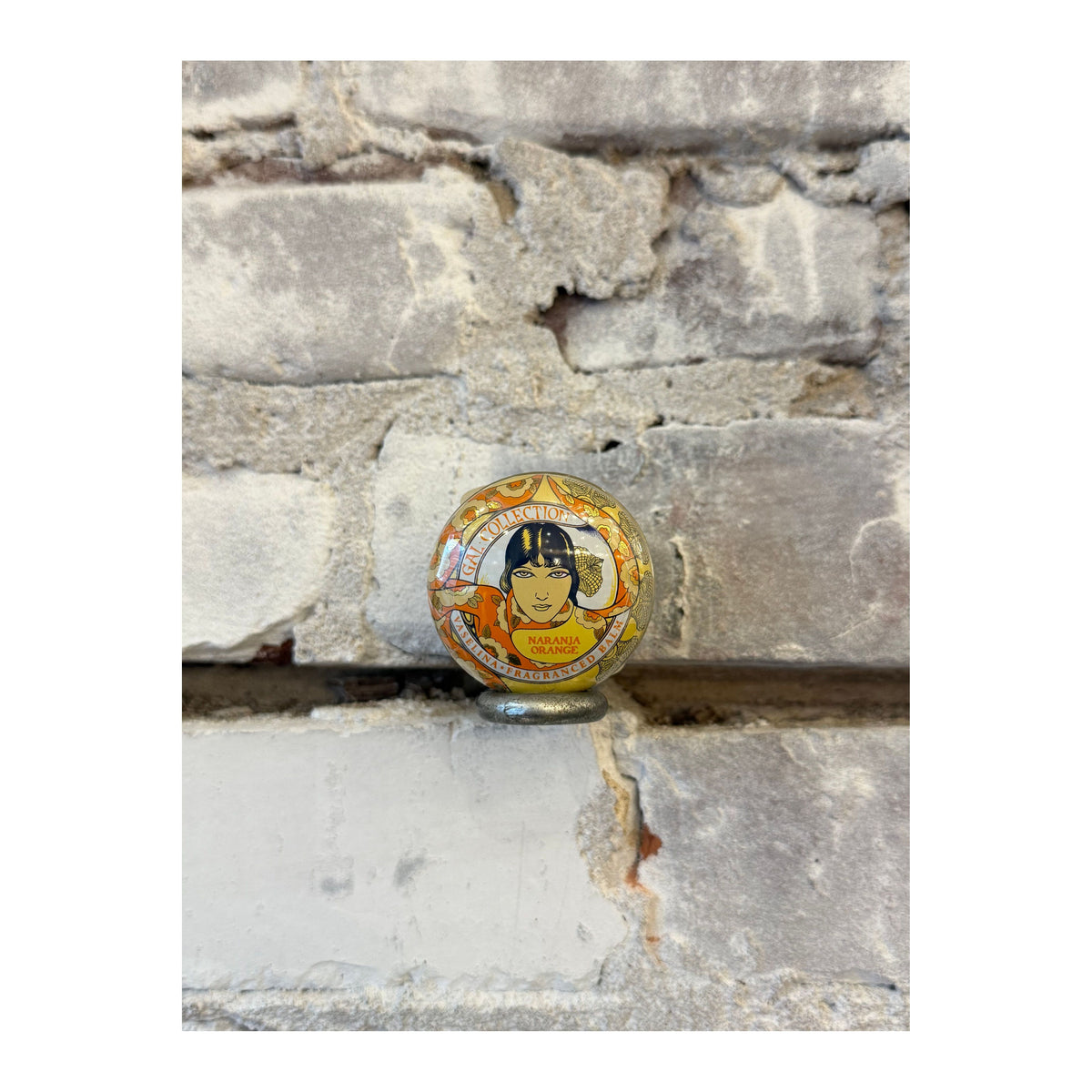 Kalastyle Soap Co. Zesty Orange Lip Balm in a small, round container, showcasing vibrant orange-colored balm inside.