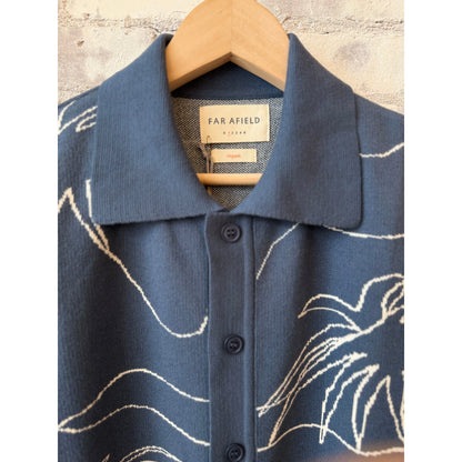 Men's Zig knitted shirt in faded navy with white palm patterns, made by Far Afield, featuring a close-up of the textured fabric.