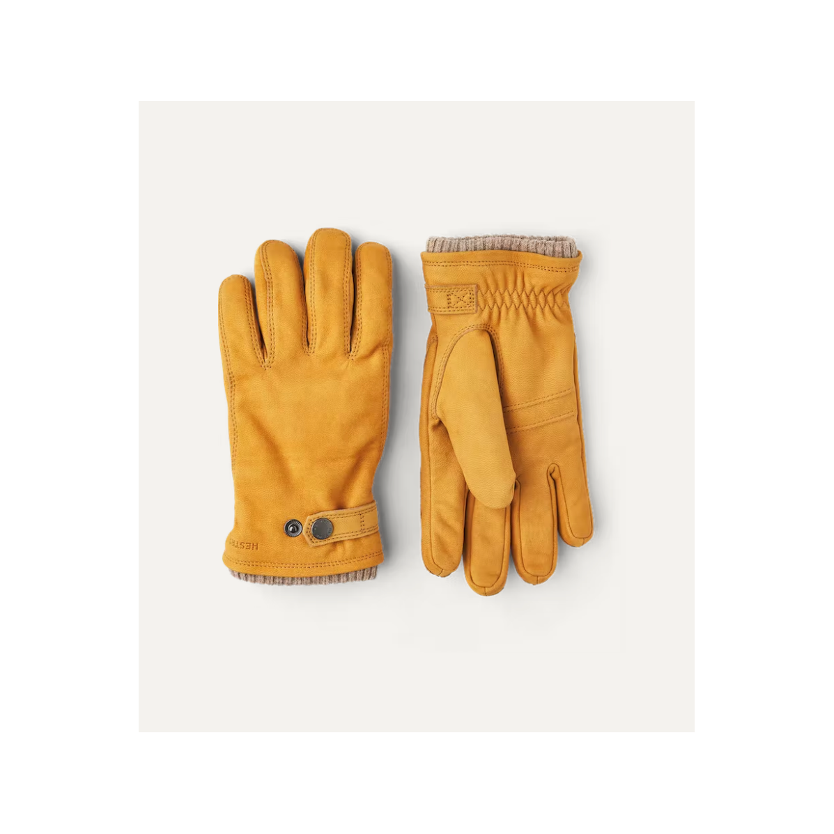 Men's Hestra Bergvik Glove in tan, showing a close-up of the insulated leather glove with detailed stitching and lining.