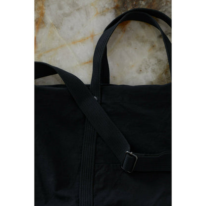 Black cotton canvas tote bag from Closed Men's accessories collection, showing sturdy handles and spacious interior.