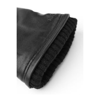 Men's Hestra John Glove in black, showcasing the stylish and warm leather glove designed for winter wear.